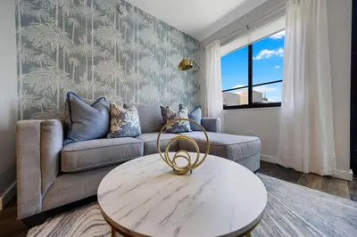 a living room with a couch and a table at Palm Paradise in DTWN 3 Min From Las Olas in Fort Lauderdale