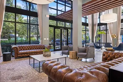 a lobby with leather furniture and large windows at Palm Paradise in DTWN 3 Min From Las Olas in Fort Lauderdale