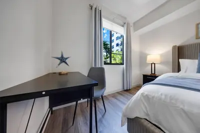a bedroom with a desk and a bed and a window at Aqua Vista in DTWN 3 Min From Las Olas in Fort Lauderdale