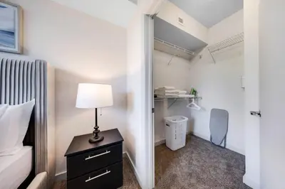 a bedroom with a bed and a table with a lamp at Coral Haven in DTWN 3 Min From Las Olas in Fort Lauderdale