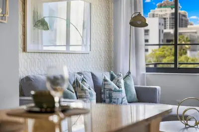 a living room with a couch and a table at Coral Haven in DTWN 3 Min From Las Olas in Fort Lauderdale
