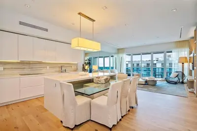 a kitchen with a dining table and chairs at Villa Royale Residences in Miami Beach