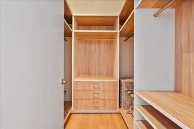 a walk in closet with wooden shelves and a door at Villa Royale Residences in Miami Beach