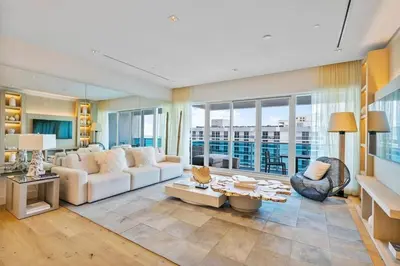 a living room with a white couch and a table at Villa Royale Residences in Miami Beach