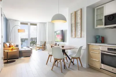a kitchen and dining room with a table and chairs at 1 BR Full Kitchen- Pool Gym Beach 29th floor in Hallandale Beach