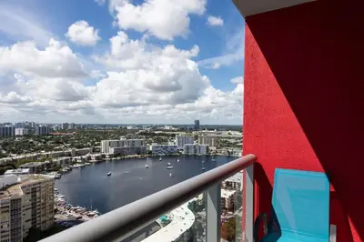 a view of a body of water from a balcony at Family Beachwalk Studio- 29th floor in Hallandale Beach
