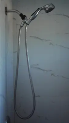 a shower with a hose attached to a wall at Cozy Miami Home Next to Wynwood & Design District in Miami