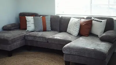 a couch with pillows on it in a living room at Cozy Miami Home Next to Wynwood & Design District in Miami