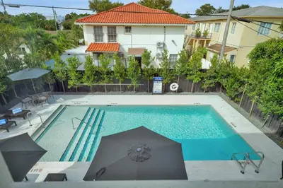 an overhead view of a swimming pool with umbrellas at Prestige Retreat by Renzzi in Miami