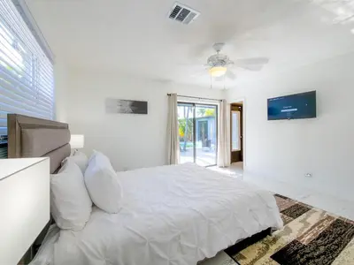 a white bedroom with a bed and a ceiling fan at Luxury,3Bed 2Bath ,Pool,Grill,Parking in Hollywod in Hollywood