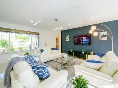 a living room with white couches and a tv at Luxury,3Bed 2Bath ,Pool,Grill,Parking in Hollywod in Hollywood