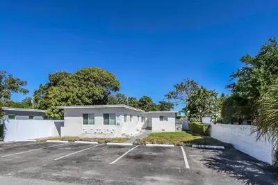 a parking lot in front of a house at Spacious North Miami Studio | 2 Queen Beds in North Miami