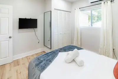 a bedroom with a bed with two towels on it at Spacious 1BR in North Miami | Near Beach & Dining in North Miami