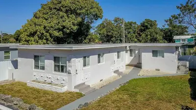 an older white house with a yard at Spacious 1BR in North Miami | Near Beach & Dining in North Miami