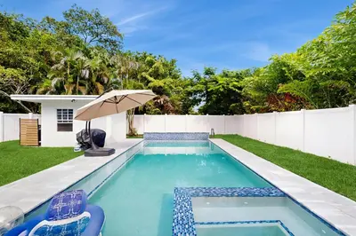 a swimming pool in the backyard of a house at Palm & Pool Retreat in Fort Lauderdale