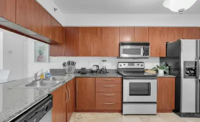a kitchen with a stove and a sink and a refrigerator at Skyline with Water views 2 bedroom in Miami