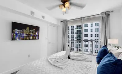 a bedroom with a bed and a large window at Skyline with Water views 2 bedroom in Miami