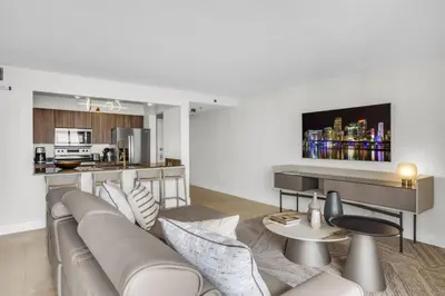 a living room with a couch and a kitchen at Stunning 3B2B with Ocean and City Views - Free Parking in Miami