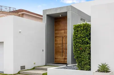 a house with a wooden door in a yard at Miami Modern Heated Pool and Dock in Sunny Isles Beach