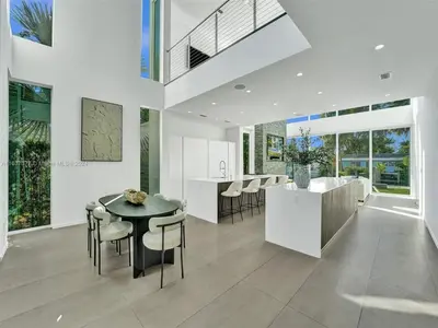 a kitchen and dining room with a table and chairs at Modern waterfront property in Fort Lauderdale