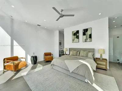 a bedroom with a bed and a ceiling fan at Modern waterfront property in Fort Lauderdale