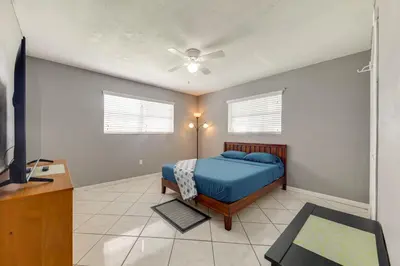 a bedroom with a bed and a ceiling fan at Fenced-In Yard Home 3 Mi to Hard Rock Stadium! in Miramar