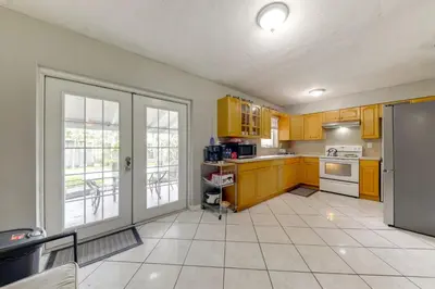 a kitchen with yellow cabinets and yellow appliances at Fenced-In Yard Home 3 Mi to Hard Rock Stadium! in Miramar
