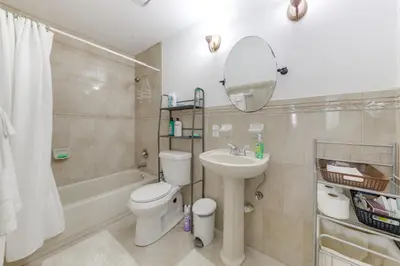 a bathroom with a sink and a toilet and a mirror at Fenced-In Yard Home 3 Mi to Hard Rock Stadium! in Miramar
