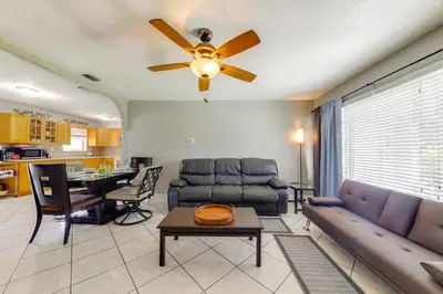 a living room with a couch and a ceiling fan at Fenced-In Yard Home 3 Mi to Hard Rock Stadium! in Miramar