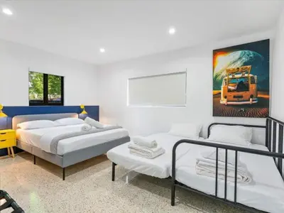 a bedroom with two beds and a painting of a truck at Miami Escape Parking Pool Near Wynwood in Miami