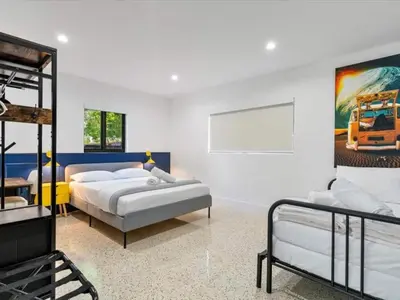 a bedroom with two beds and a mirror at Miami Escape Parking Pool Near Wynwood in Miami