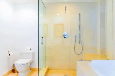 a bathroom with a shower with a toilet and a sink at Luxury Living in Brickell - Stunning City Views in Miami