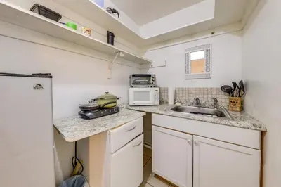 a small kitchen with a sink and a microwave at 8 Mi to Beach! Miramar Guest Suite with Pool Access in Miramar