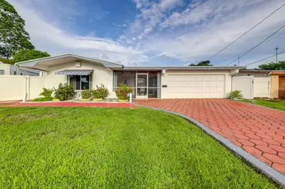 a house with a brick driveway at 8 Mi to Beach! Miramar Guest Suite with Pool Access in Miramar