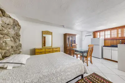 a bedroom with a bed and a kitchen with a table at 5 Mi to Hollywood Blvd! Miramar Apt with Shared Pool in Miramar