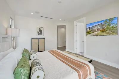 a bedroom with a large bed and a tv on the wall at New 4BR Upscale Family Haven in Fort Lauderdale