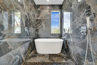 a bathroom with a white tub and a window at New 4BR Upscale Family Haven in Fort Lauderdale
