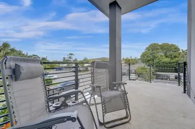 a porch with a chair and a fence at New 4BR Upscale Family Haven in Fort Lauderdale