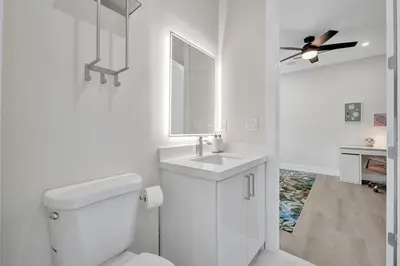a white bathroom with a toilet and a sink at New 4BR Upscale Family Haven in Fort Lauderdale