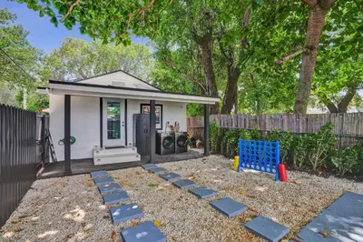 a backyard with a small house with a blue chair at Miami Heart Retreat, Stylish & Central With Games in Miami