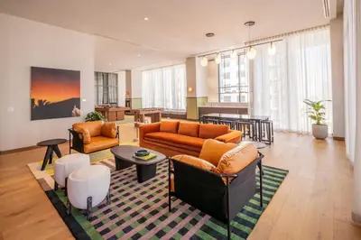a living room with two couches and a table at The Crosby Miami World Center in Miami