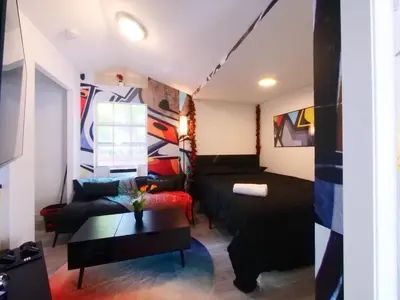 a living room with a couch and a table at Miami Wynwoods nook the graffiti stylish studio in Miami