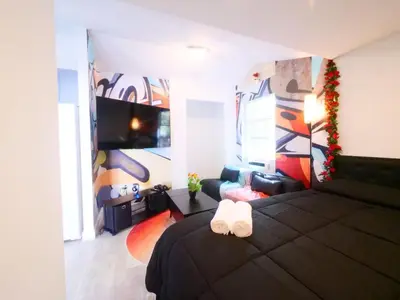 a bedroom with a black bed with a white towel at Miami Wynwoods nook the graffiti stylish studio in Miami