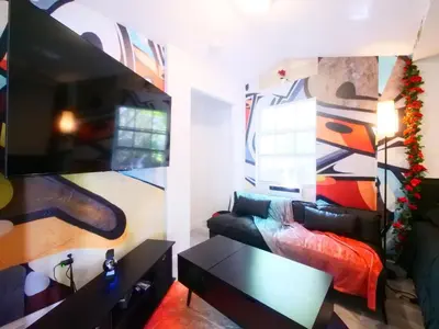 a living room with a couch and a table at Miami Wynwoods nook the graffiti stylish studio in Miami