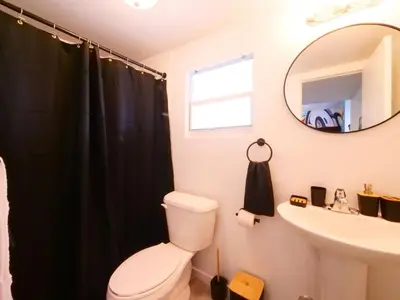 a bathroom with a toilet and a sink and a mirror at Miami Wynwoods nook the graffiti stylish studio in Miami