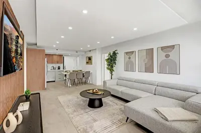 a living room with a couch and a table at Modern 4BR with Ocean Views Pools and Direct Beach Access in Miami Beach