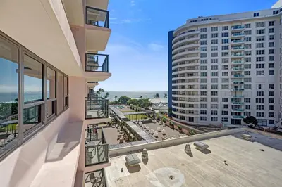 an apartment balcony with a view of the ocean at Modern 4BR with Ocean Views Pools and Direct Beach Access in Miami Beach