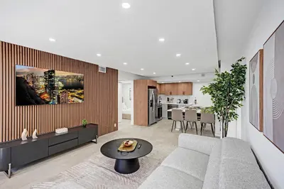 a living room with a couch and a table at Modern 4BR with Ocean Views Pools and Direct Beach Access in Miami Beach