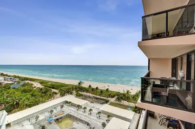 a view of the ocean from the balcony of a building at Steps to the Beach 3BR 2BA Condo Resort Perks and Ocean Glimpse 1406 in Miami Beach