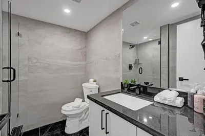 a bathroom with a sink and a toilet and a shower at Miami Beach Paradise 4BR Stylish condo with Resort Perks 1007 in Miami Beach